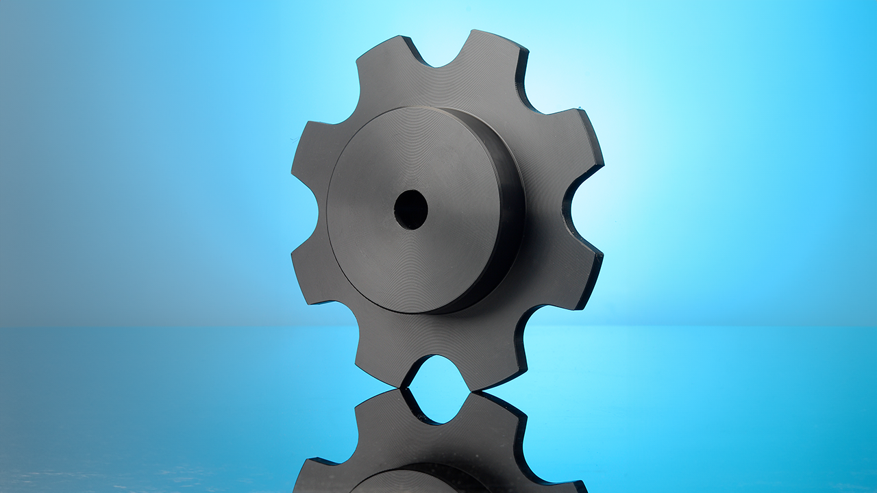 Black plastic sprocket with chain teeth